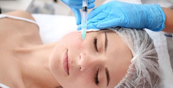 Een schoonheidsspecialist voert een gezichtshuidverjongingsprocedure uit met plasma